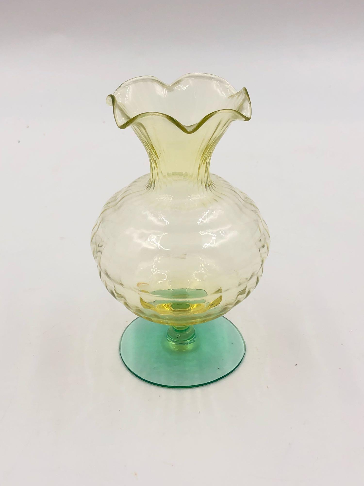 Floral Uranium Glass Vase: Floral Uranium Glass Vase This vase features an accentuated handkerchief rim with a glowing accent. The body is spherical and it stands at 5 inches tall, 2 wide and 2 long.