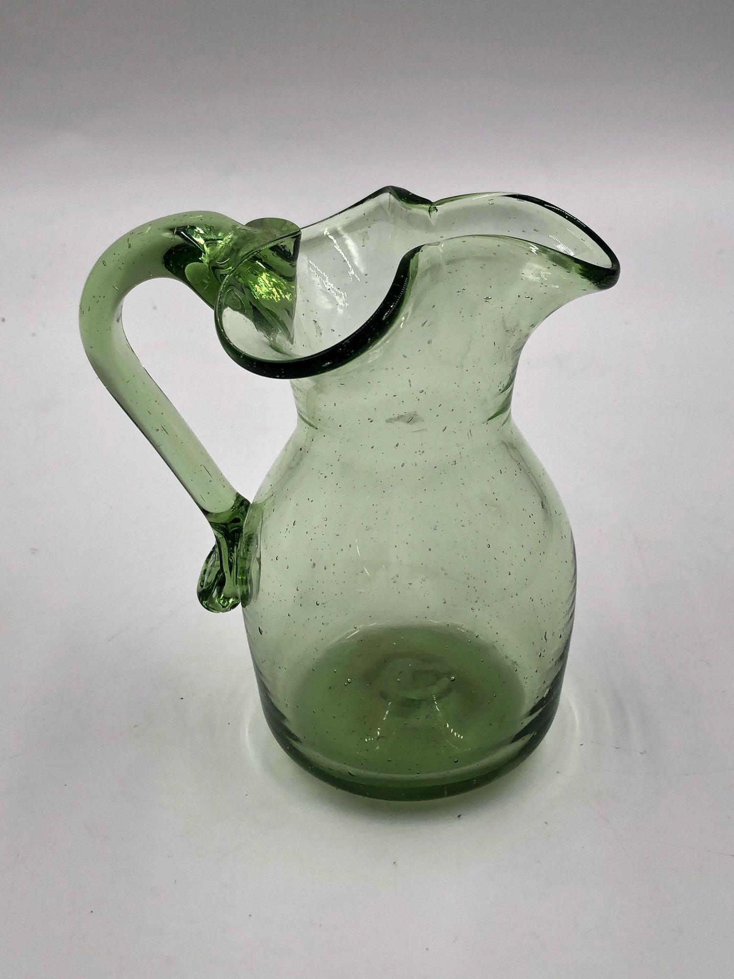 Green Handkerchief Pitcher: Green Handkerchief Pitcher This green pitcher features a clover shaped rim that tapers into its boxy base. The piece sits at 5" tall, 4" long and 5" wide.