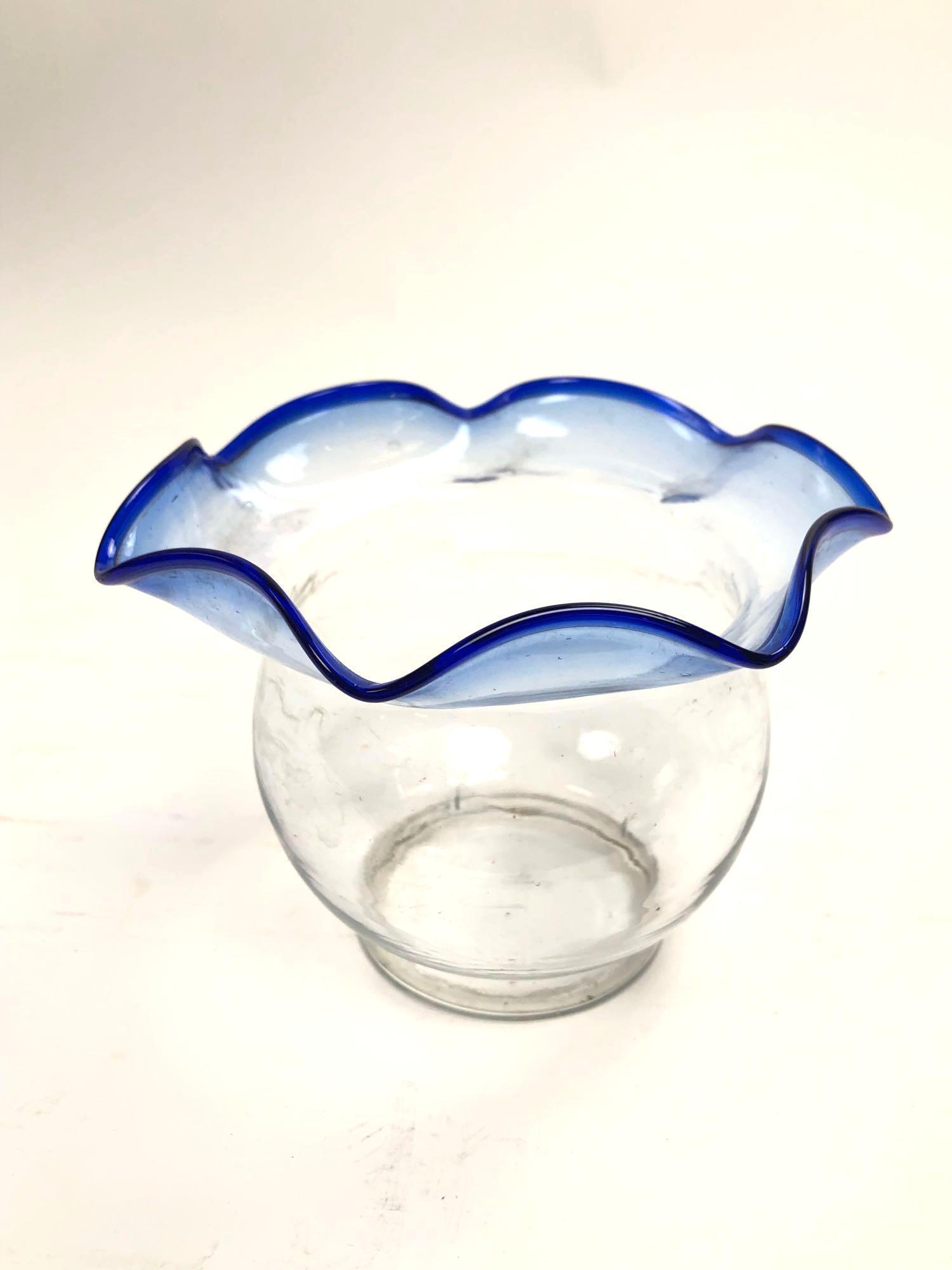 Cobalt Blue Rimmed Glass Vase: Cobalt Blue Rimmed Glass Vase Clear glass vase with cobalt blue handkerchief rim. Measures 4.5 inches tall and 3 inches in diameter at its base.