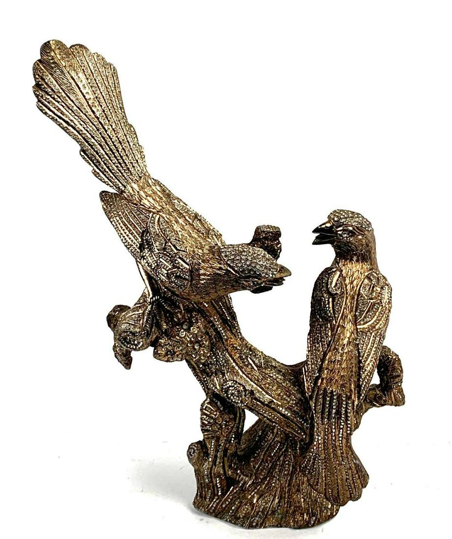 Decorative Birds on a Branch sculpture: Bird sculpture is made out of metal with decorative rhinestones throughout the birds feathers and branch. The metal is etched with patterns and designs creating texture throughout the sculpture. 14 in