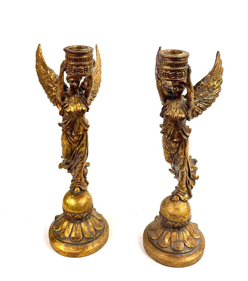 Art Deco Gold Gilded Angel Candle Stick Holders: Two angel candle stick holders measure to be 16 inches. Each angel stands on one leg balancing on a rounded base as they hold one leg behind them.. Their robes are long and flow around their body as i