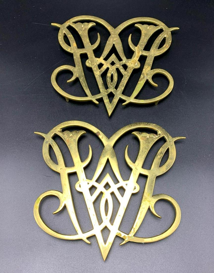 Colonial Williamsburg Virginia Metal Crafters: Vintage 1950 Colonial Williamsburg Virginia Metal Crafters Queen Ann Cypher brass trivets. Approximately 1 inch tall by 9 inches long by 10.5 inches wide.