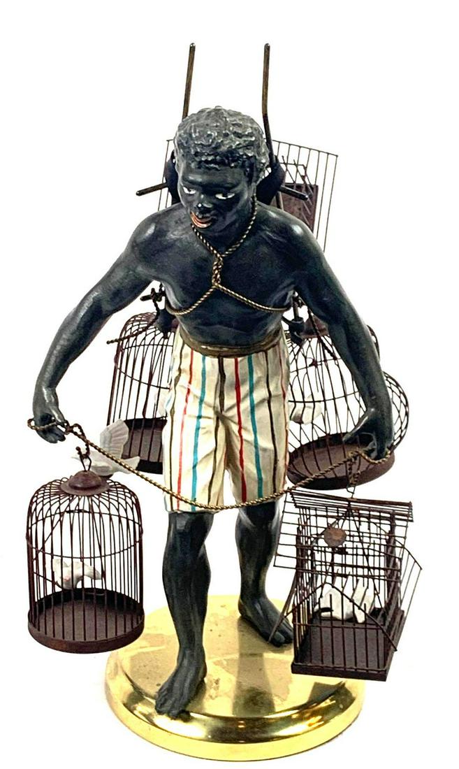 Petite Choses Blackamoor Nubian Man w/ Bird Cages: Antique Petite Choses Blackamoor Nubian figurine/Statue of Man with Bird Cages Medium: Mixed Media Dimensions: Art: 14" X 6" X 6" Condition: Excellent Figurative sculpture of a man in striped shorts a