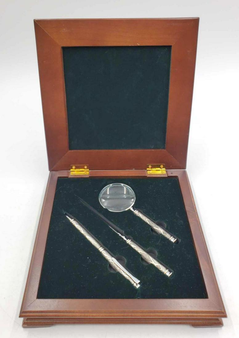 Desk Set: Wooden box containing a magnifying glass, a pen, and a letter opener. Each is ornately designed with metal workings and comes in a nice wooden box lined with felt, the box is 1.5x8.25x8.25 inches in s