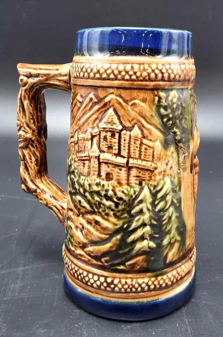 Beer Stein: Ceramic beer stein from Denmark, this 7 inch tall stein is decorated with men and woman drinking and a landscape scene.