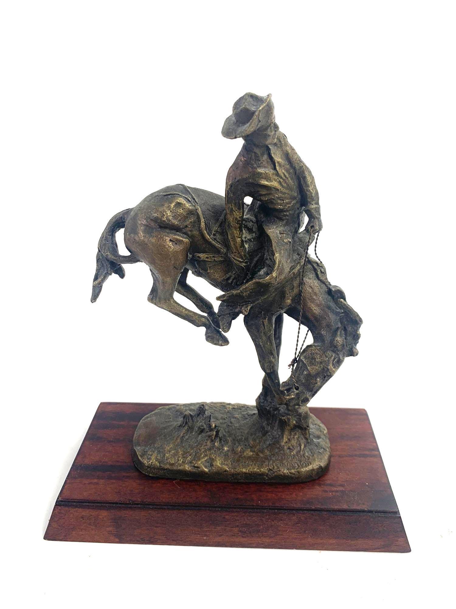 Fredrick Remington Sculpture: Sculpture replica of Remington's The Outlaw. Piece was minted in 1988 by the Franklin Mint. Piece is official issue of the Fredrick Remington Museum. Piece is of a cowboy and a horse. Piece comes with