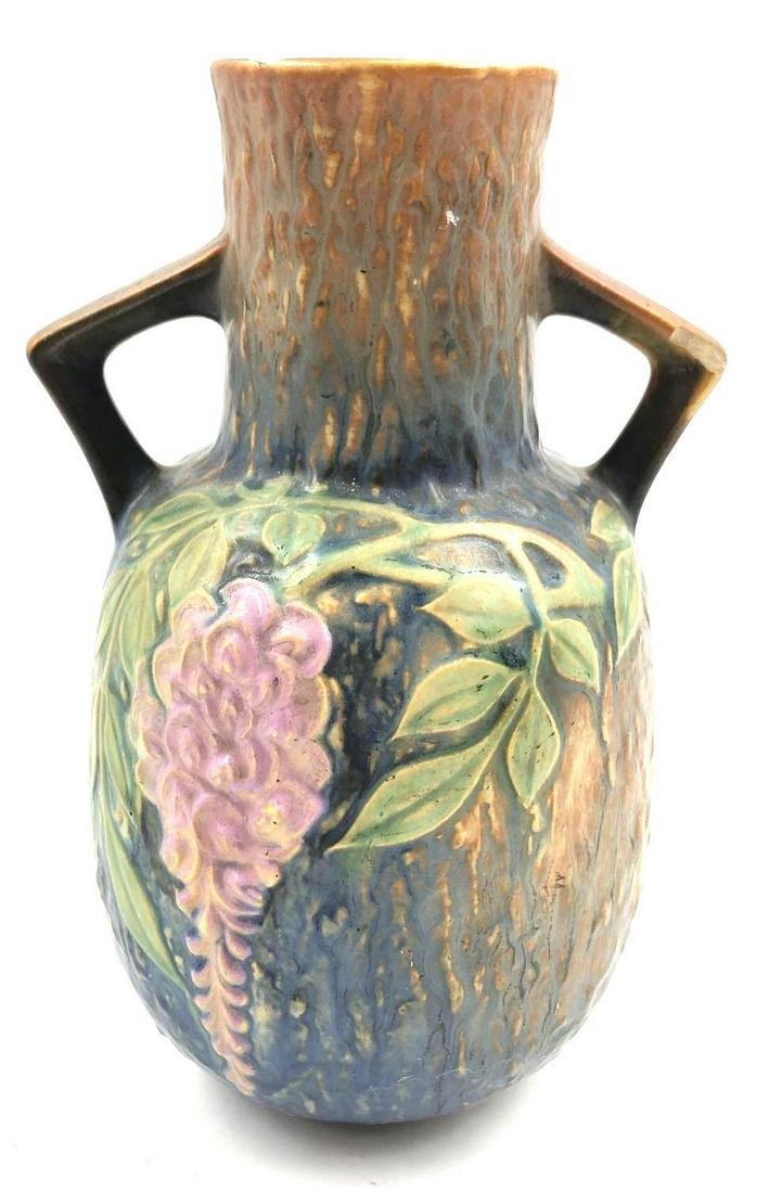 Roseville Pottery Wisteria Vase Circa 1933: Roseville Pottery Wisteria Vase Circa 1933 This amphora vase features a raised image of a wisteria vine with a blue and brown textured background. The vase is 9.25 inches tall and 6 inches at its wide