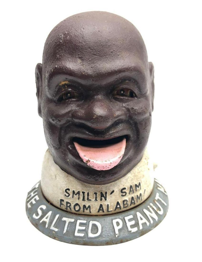 Cast Iron Smilin Sam Mechanical Bank: Vintage Black Americana "Smilin Sam From Alabama, The Salted Peanut Man" cast iron mechanical bank. It measures 6 inches tall with a base diameter of 5 inches.