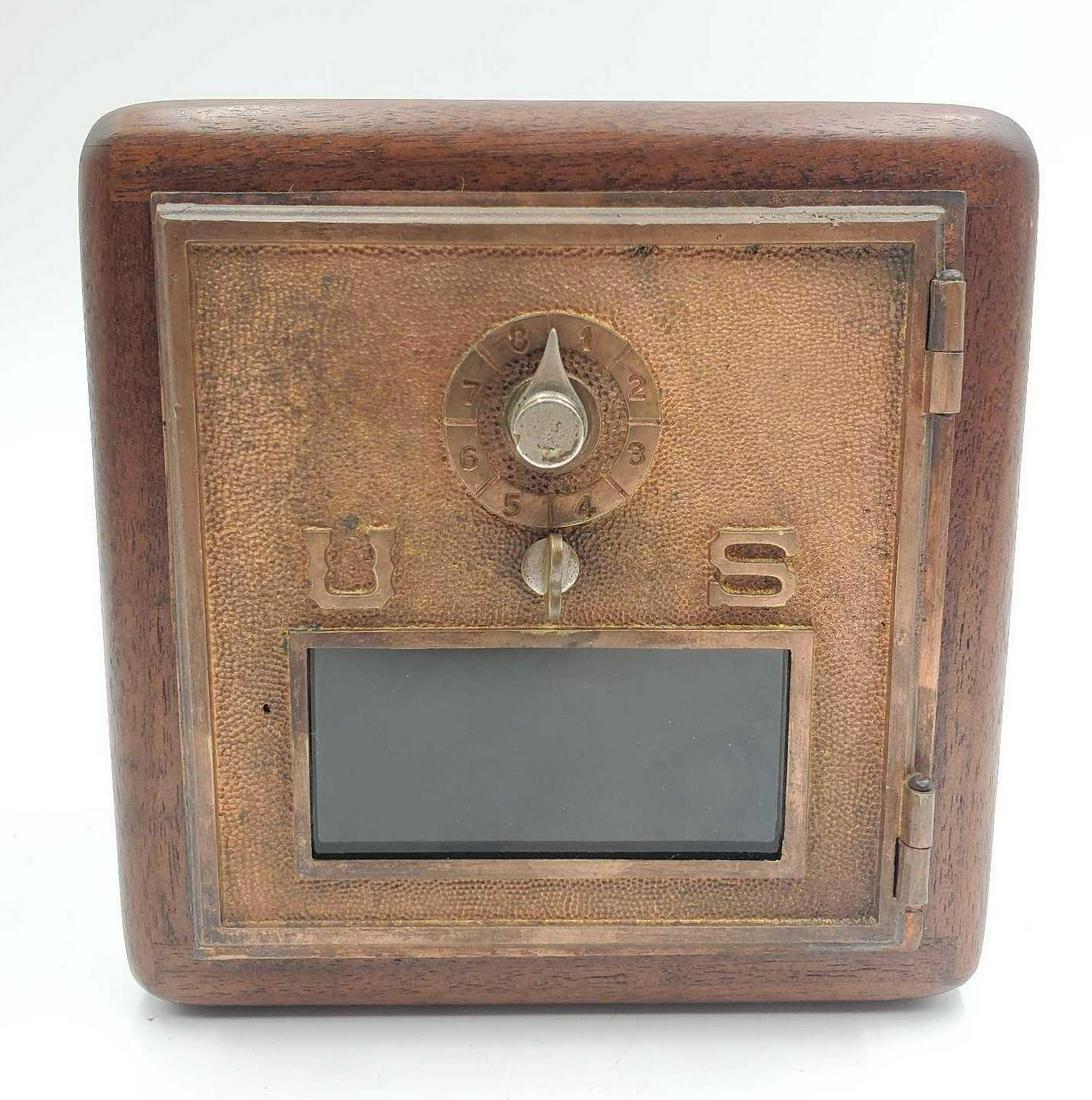 US Post Office Lock Box: Vintage US Post Office lock box is made of wood with a metal door and combination lock. The code for the lock is unknown. This box is 7.5 inches tall, 7 inches wide and 5.4 inches deep.
