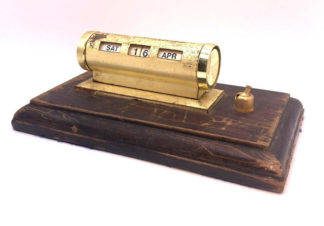 Vintage Perpetual Scrolling Desk Calendar: Vintage scrolling desk calendar has knobs on either side that change the day and month accordingly. Calendar is mounted to a wooden base. Measures 7.75 inches wide 4.5 inches deep and 2.75 inches tall