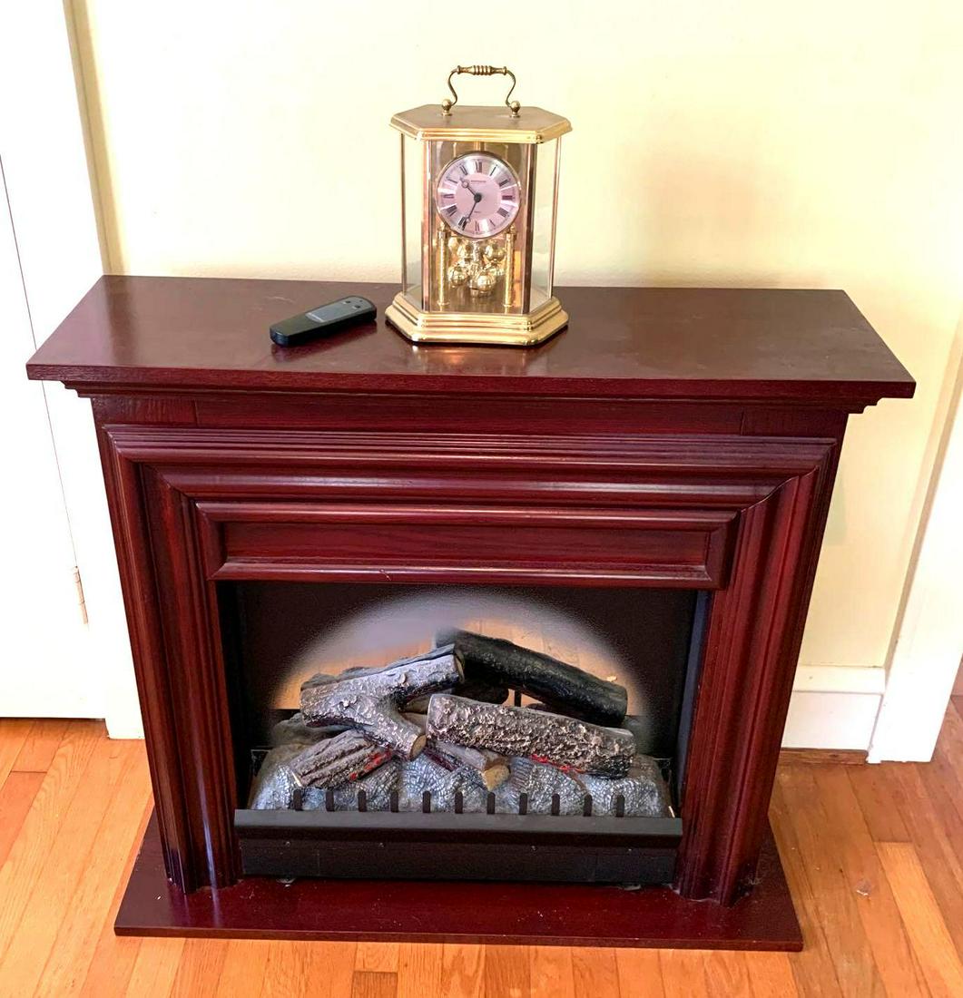 Dimplex Heater and Clock: Dimplex Air heater serial number 26606D4F 385 and faux fireplace mantel surround made by Jenson Co. Model Number 3900-MC-Q. It measures 35.5 inches long by 12 3/8 inches deep by 32.25 inches tall. Wit