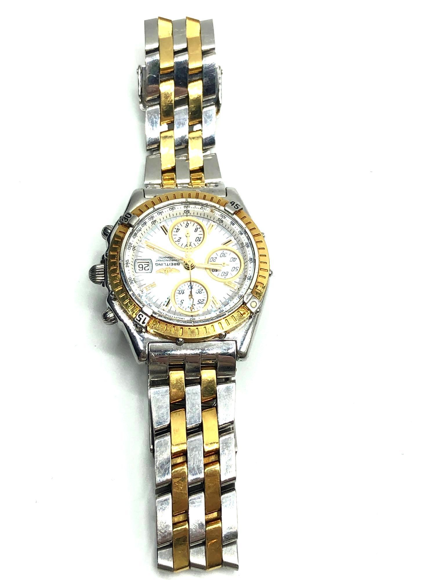 Authentic 18k Breitling D13350 Watch: Breitling Model D13350 stainless steel and 18k gold watch with a mother of pearl dial. Time-lapse bezel frames a mother of pearl dial with three chronograph sub-dials trimmed in gold. Date window is a