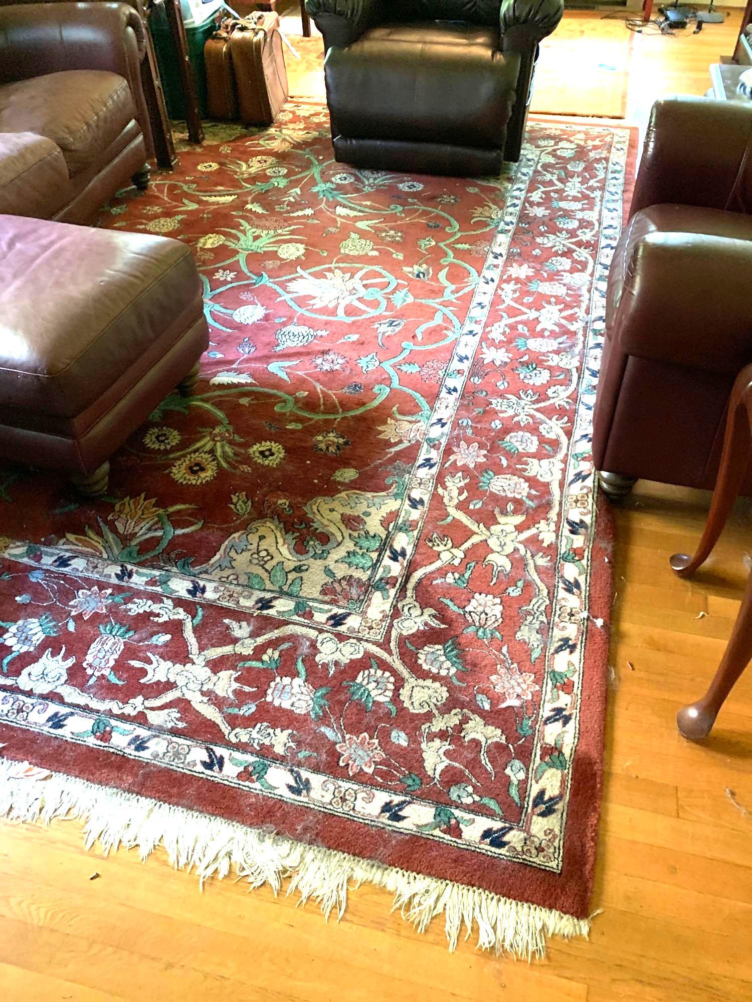 Large Area Rug: Large red area rug with a floral design. Some of the fringe is missing. It measures approximately 151 inches long by 107.5 inches wide. ** Notice: This lot is located, in Hampton, Virginia. It require