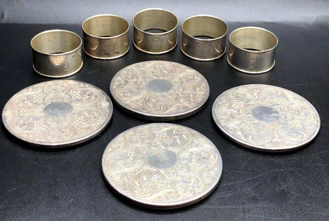 Sterling Silver Napkin Ring and Plated Coasters: 5 Sterling silver napkin rings are made by Gorham and measure 1 inch tall with a diameter of 2 inches, rings have a combined weight of 2.9855 ozt or 92.86 grams. The 4 silver plated coasters are made