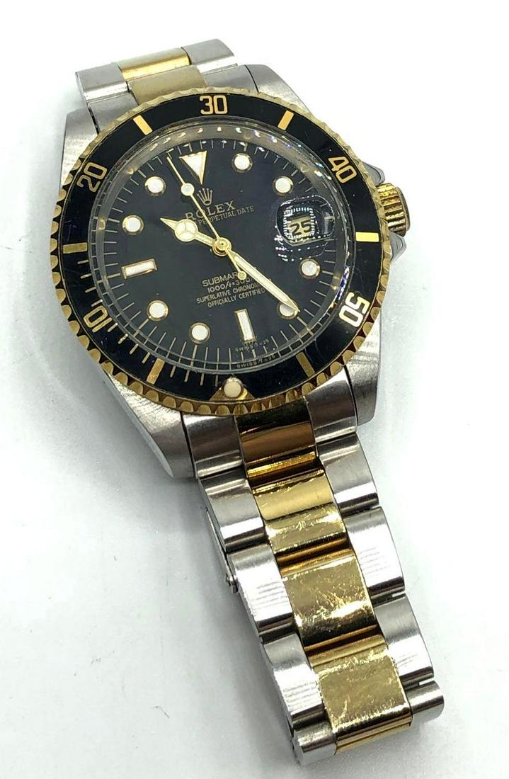 Rolex Submariner Wrist Watch: Replica Rolex oyster perpetual date Submariner watch with a superlative chronometer, is not currently working. It measures 8.25 inches long and it’s face measures 1.6 inches wide.