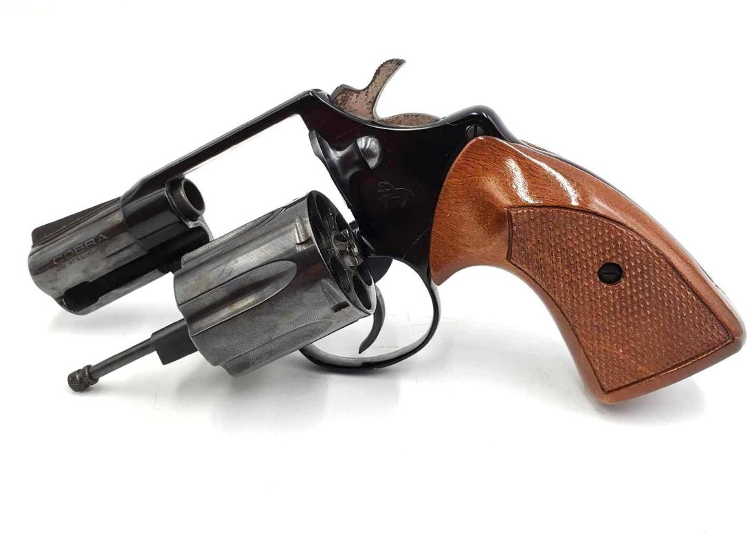 Cobra .38 Special CTG Revolver: Cobra .38 special CTG revolver made by Colt, gun is blue steel with checkered walnut grips. Gun is double action and the serial number is F99830. Gun is 4.5 inches tall and 7 inches long.