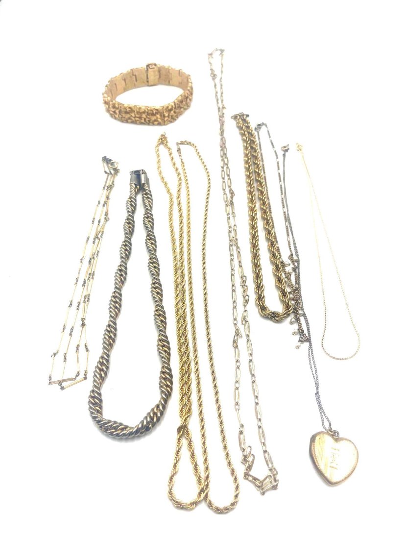 Costume Jewelry: A collection of costume jewelry including Monet gold chain 15 inches, as well three twisted chains. Lengths are 16 inches, 20 inches, and 21 inches. One chain with white pearl like beads 15 inches. Go