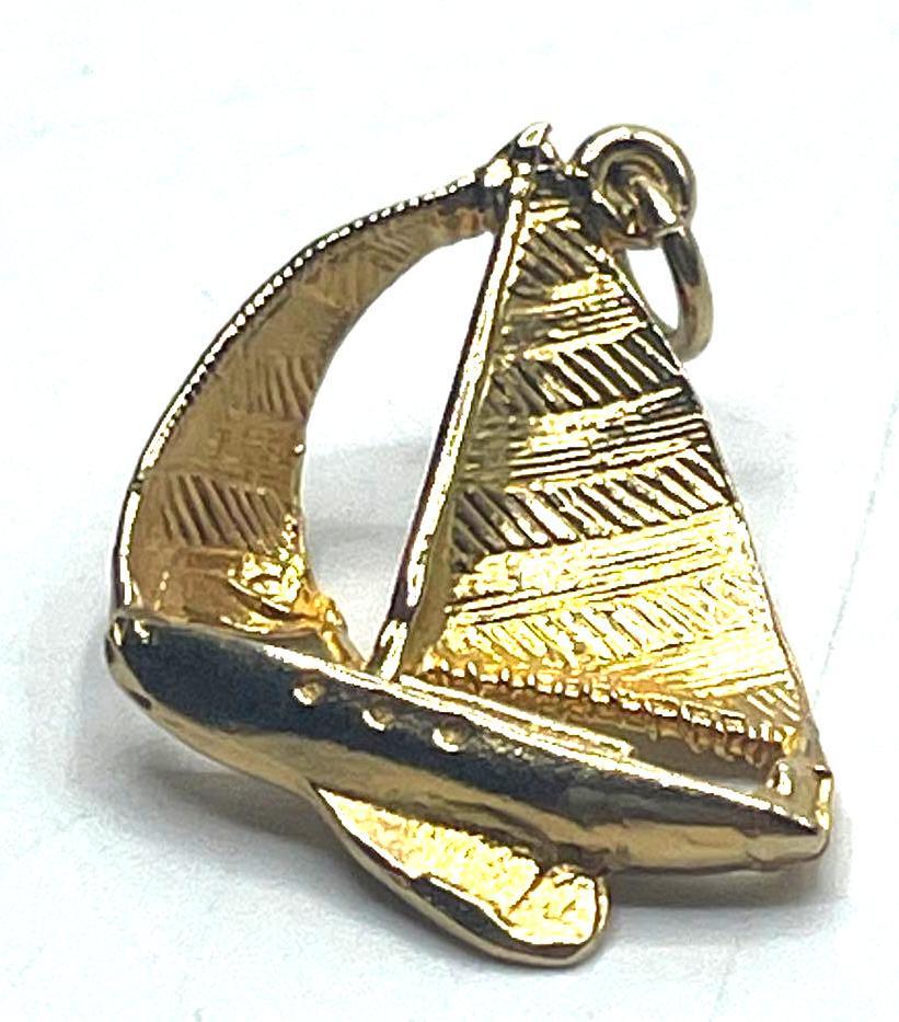 Gold Toned Sailboat Pendant: Gold Toned Sailboat Pendant, constructed into the shape of a sailboat. A small loop can be found attached to the top of the sail boat's mast. Pendant weighs a total of 0.10 ozt and 1 inches in le