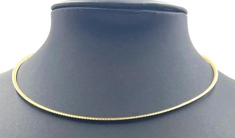 14kt Gold Choker: 14kt Gold Choker. This necklace features both white and yellow 14kt gold on opposite sides. Choker has a 5.25 inch diameter and weighs a total of 0.112 ozt. The 14k stamp can be found on the chok