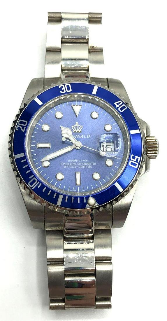 Reginald Men's Wrist Watch: Men's wrist watch made by Reginald, features a blue clock face and is water resistant up to 1000 feet. Watch is made from stainless steel and measures 4 inches long laid flat and 1.75 inches wide at i