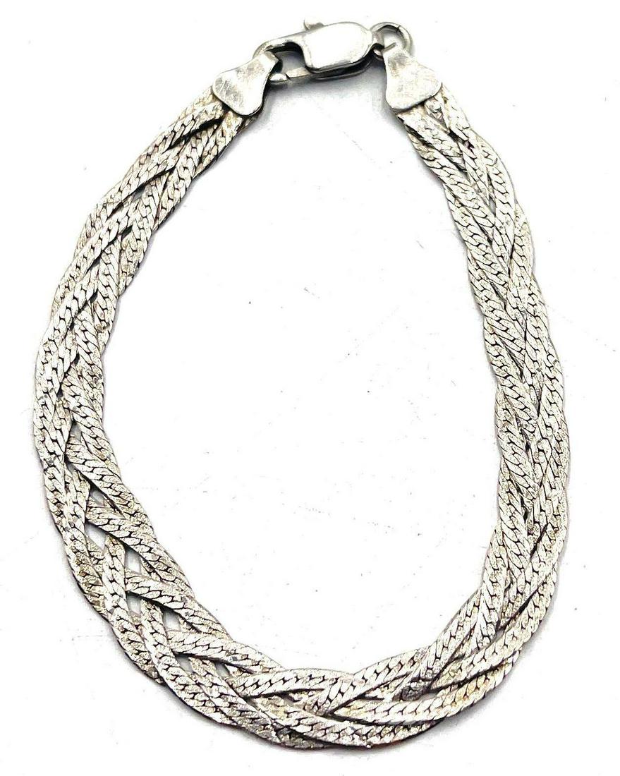 Italian Sterling Silver Fish Braid Tail Bracelet: Italian sterling silver bracelet, consisting of four sterling silver chains connected together in a fish tail braid design. 925 and Italy stamps can be found on bracelet clasps. Bracelet is 7.25 inche
