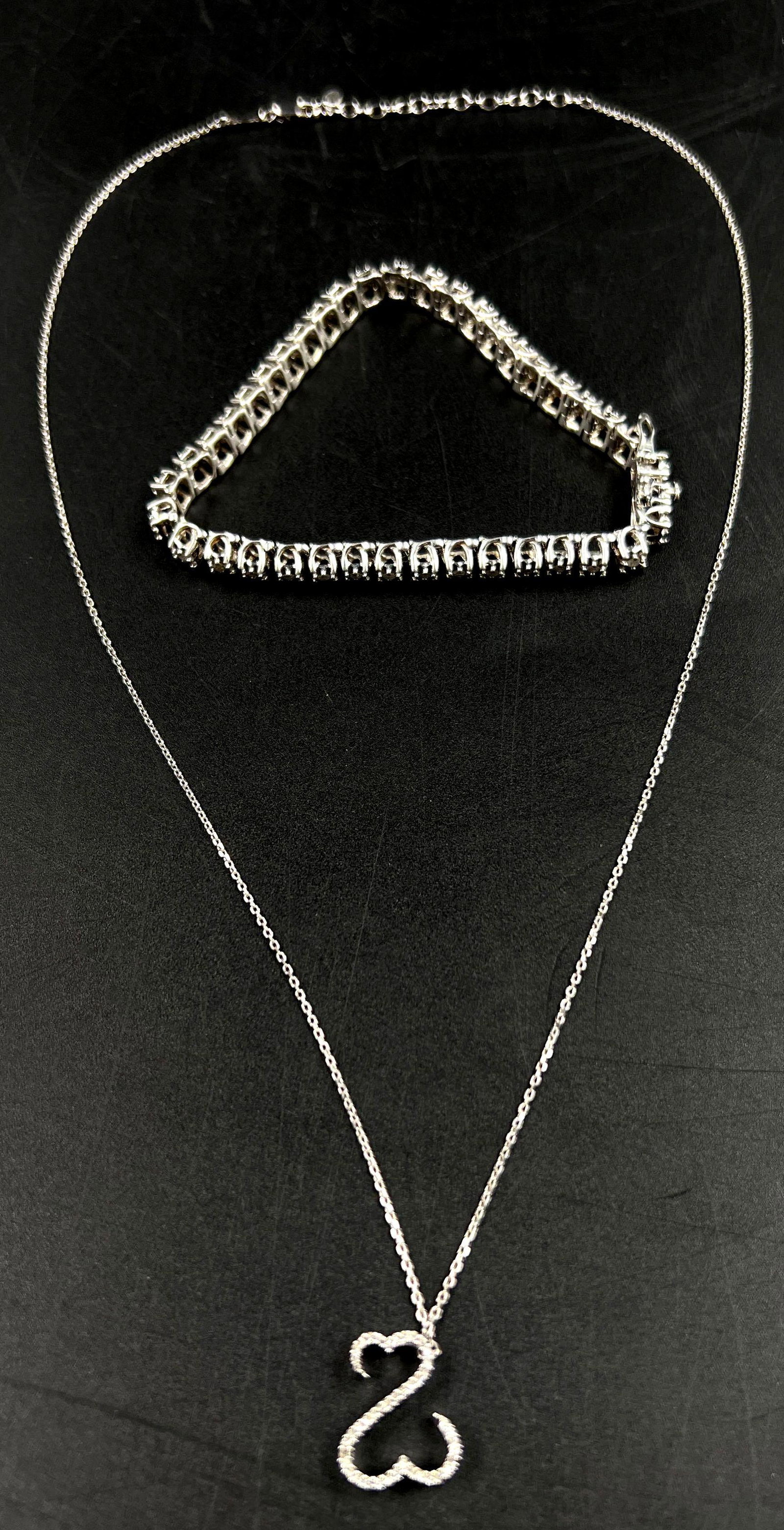 14kt White Gold Necklace and Sterling Silver Diamond Tennis Bracelet: 14kt White Gold Necklace and Sterling Silver Diamond Tennis Bracelet. The sterling silver diamond tennis bracelet weighs 0.44 ozt and an approximate diameter of 2.5 inches. There are 40 round cut diam
