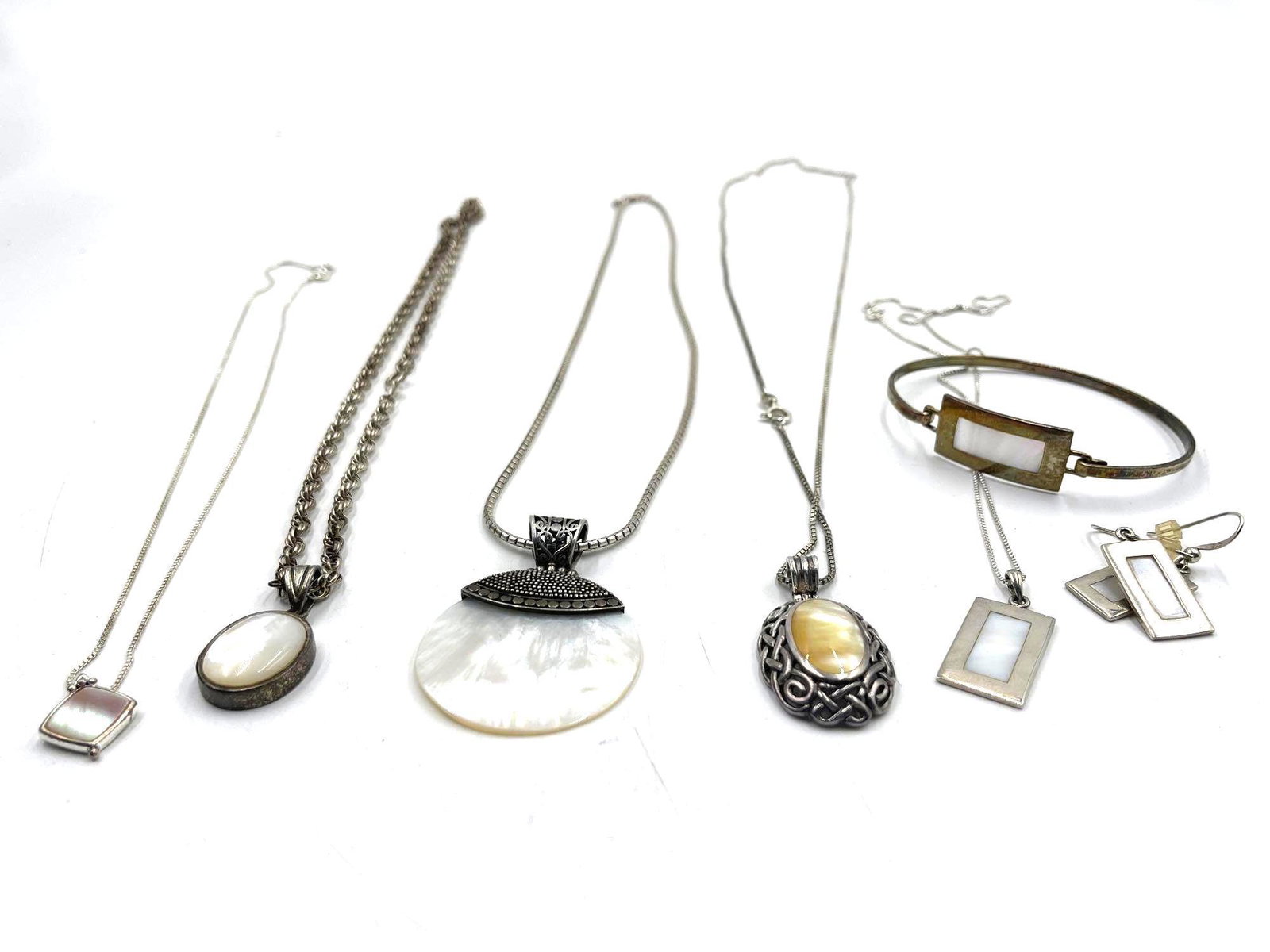 Collection of Sterling Silver Jewelry: Collection of Sterling Silver Jewelry. This lot includes a variety of different necklaces, a bracelet, and a pair of earrings. There are seven individual jewelry pieces. Some pieces come with what app