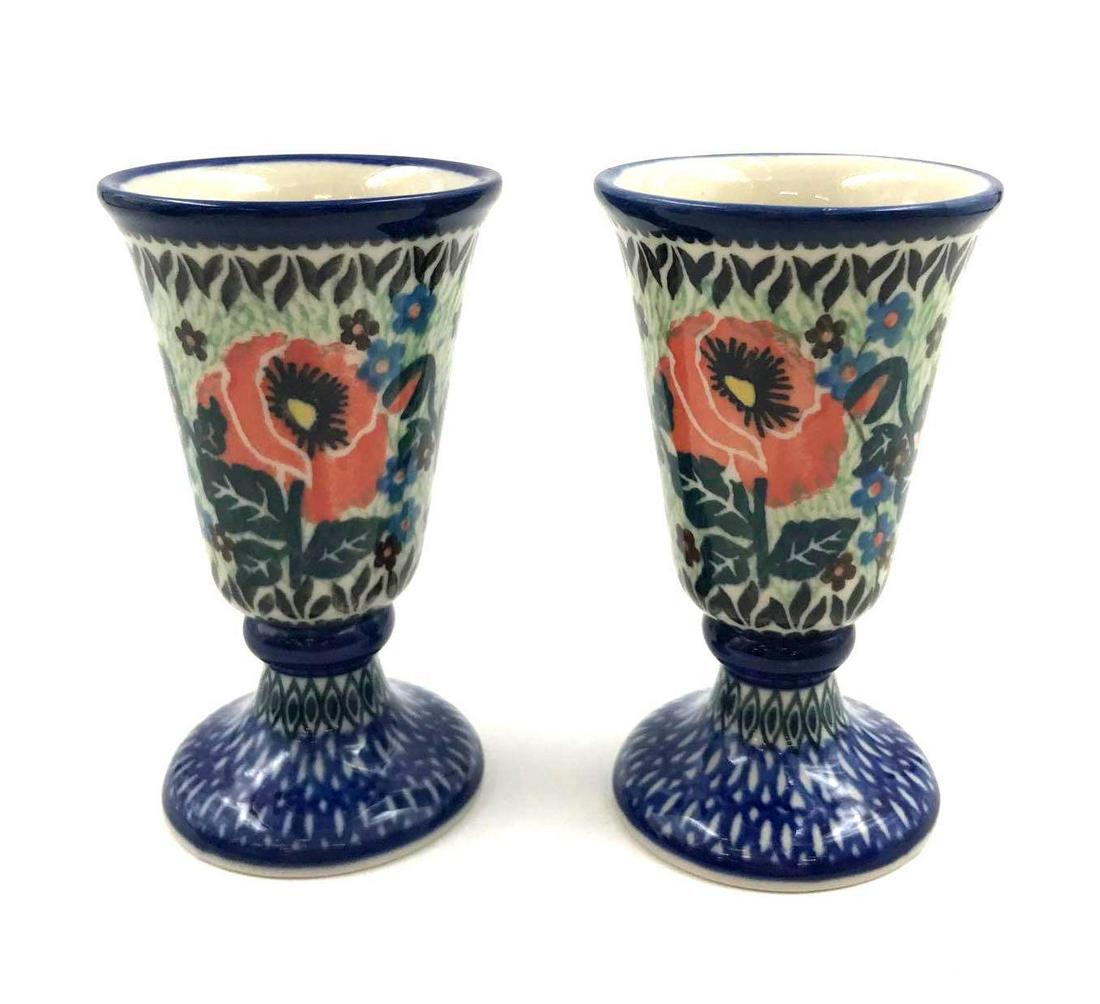 Unikat Polish Pottery Footed Goblet Cups: Unikat Polish Pottery Footed Goblet Cups. Both cups have light red poppy flowers with red and yellow centers. They also have blue and brown and green leaves and blue and black patterns and outlines. T