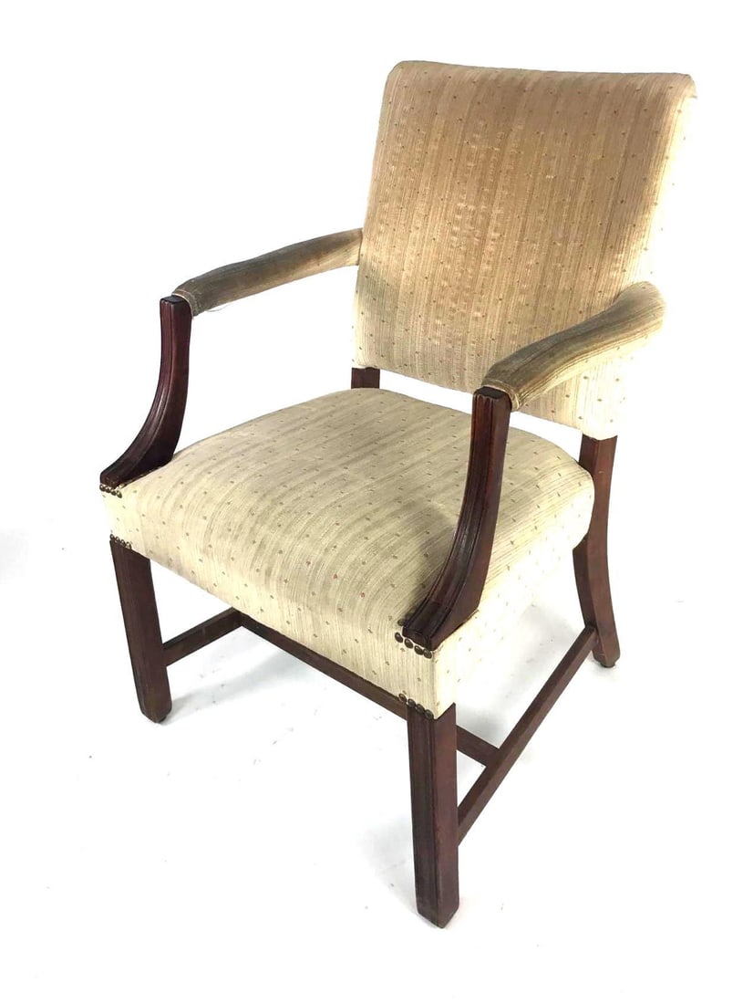 Mahogany Chippendale Library Chair: Mahogany Chippendale Library Chair. This carved mahogany upholstered chair features curved arm supports, and Marlborough front legs connected to saber back legs by an "H" stretcher. The chair measures