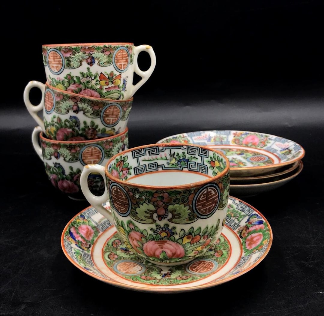 Rose Canton Porcelain Teacups and Saucers: Rose Canton Porcelain Teacups and Saucers. A set of eight Rose Canton teacups and saucers depicting, butterflies, roses, and medallions. There is some light cracking on one of the teacups. Each teacup