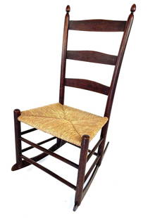 Antique Mt Lebanon Shaker Rocker: Antique Mt Lebanon Shaker Rocker. An antique youth shaker rocker featuring a 3-slat ladder back, finials on the stiles, and a rush seat. Mt. Lebanon, MA Circa 1860. The rocker measures 17 x 22 x 34 in