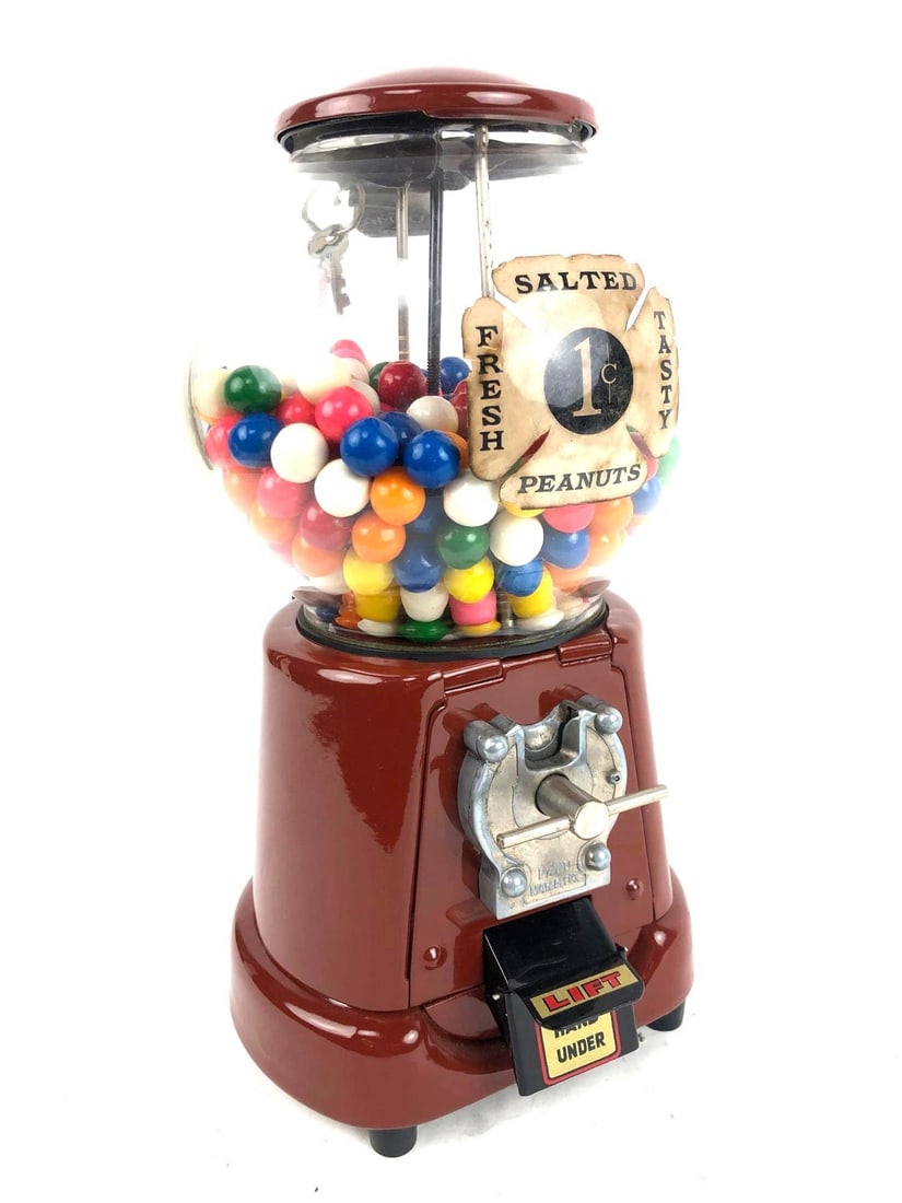 Red Amco Gumball Machine: Red Amco Gumball Machine. It has a red base and top and comes with keys. The machine accepts 1 cent. The gumball machine has been restored. Manufactured by Amco, and patented March 8, 2004. It appears