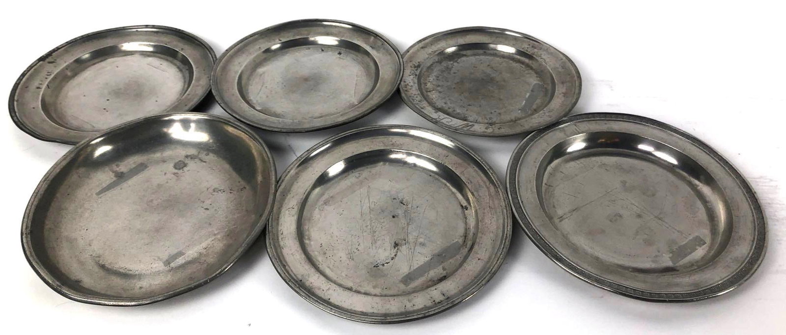 19th Century Antique Pewter Plates: 19th Century Antique Pewter Plates, this set comes with a total of 10 German-made pewter plates that range in size from 8.25in. to 9.5in each. Makers marks are locDated on the bottom of the dishes.
