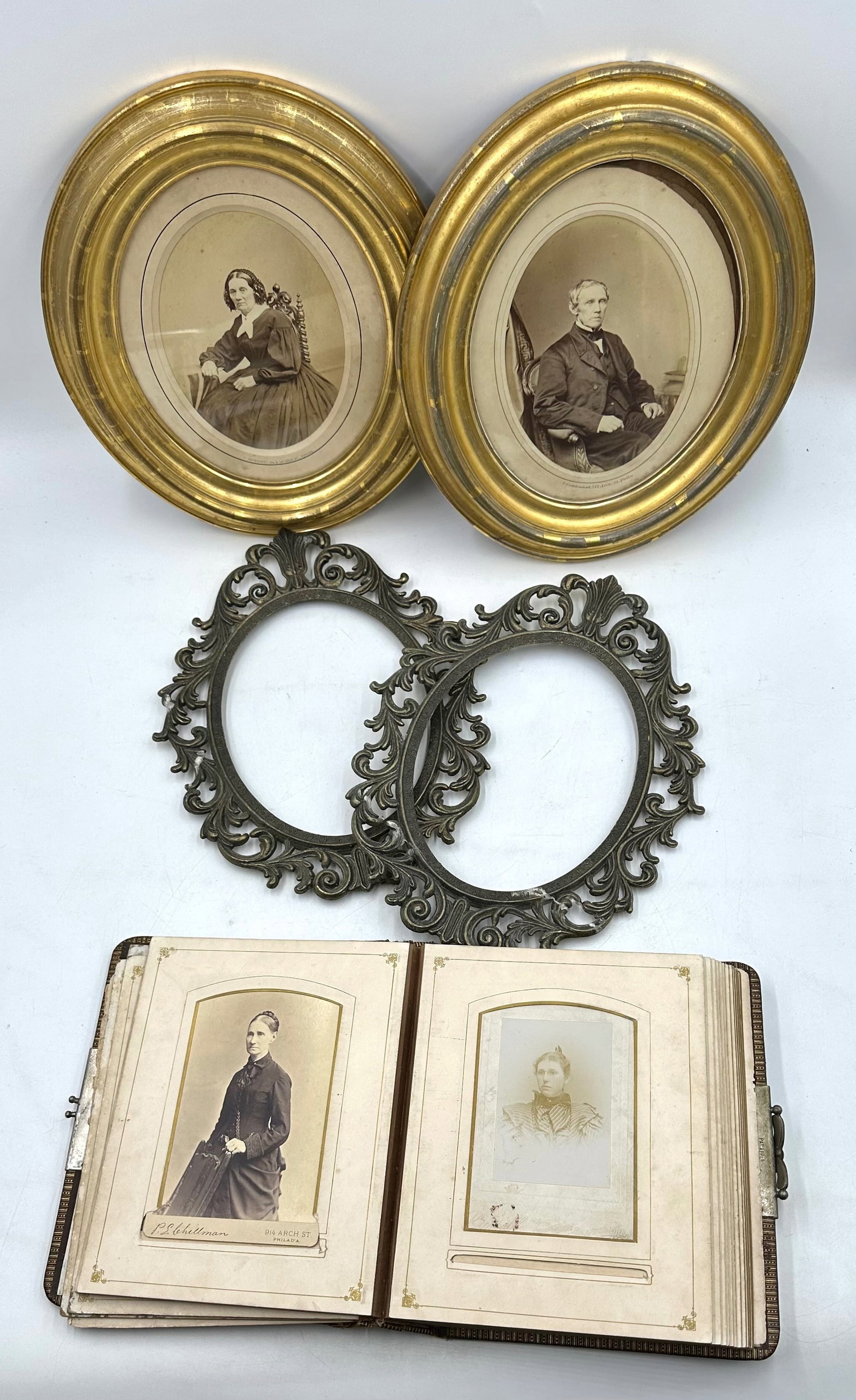 Antique Photo Album and Pair of Antique photos in Frames: Antique Photo Album and Pair of Antique Photos in Frames. Includes an antique photo album with photographs of family members, women, men, and children from around the mid to late 1800s. Also includes 