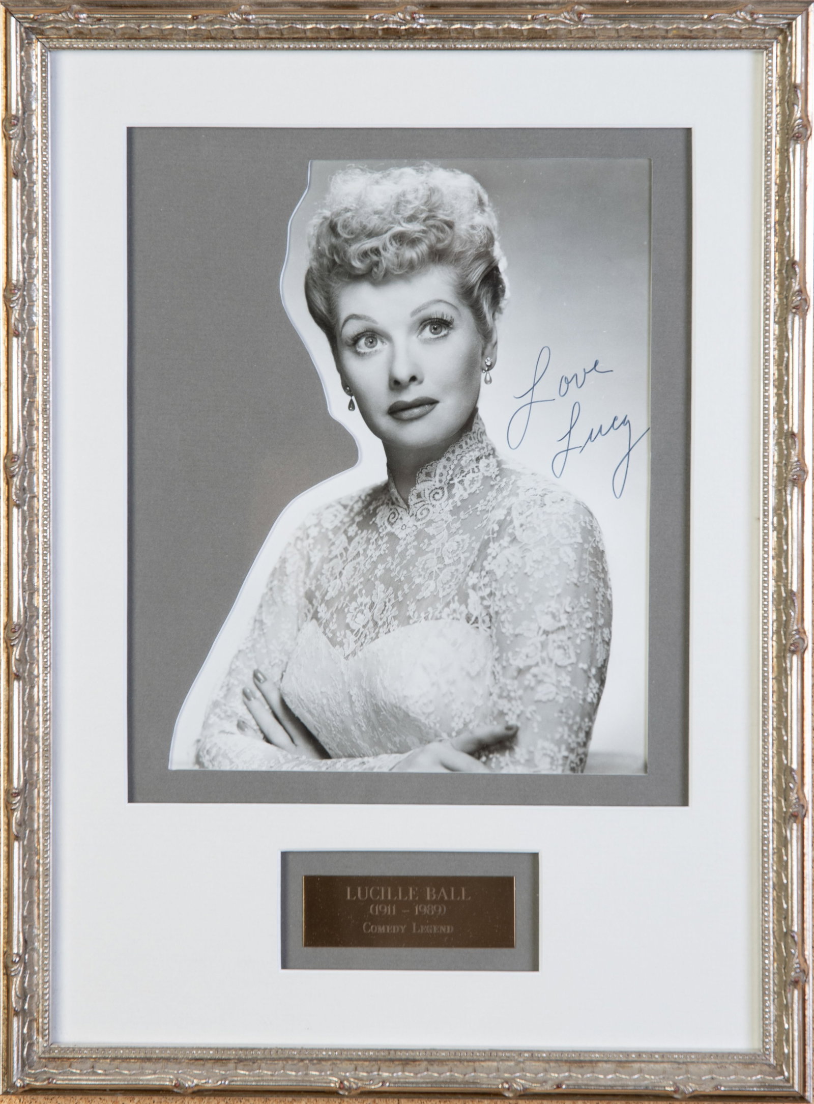 Lucille Ball 1911-1989 Photograph with Signature, Women in History: Lucille Ball 1911-1989 Photograph with Signature, Women in History The piece is a framed black and white photograph of Lucille Ball with her signature which says Love Lucy. The piece has a plaque with