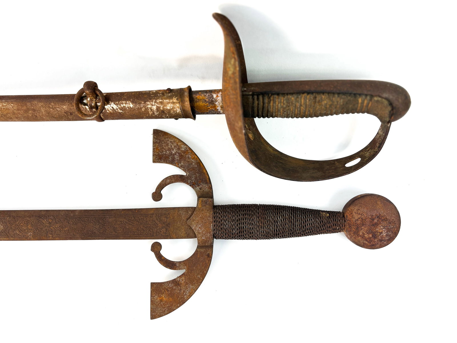 Pair of Swords: Fabra De Toledo 1891 Infantry Sword with metal scabbard. The scabbard and hilt are rusted, along with the top of the blade. But the blade overall is in good condition. The sword measures 36in x 5.5in 
