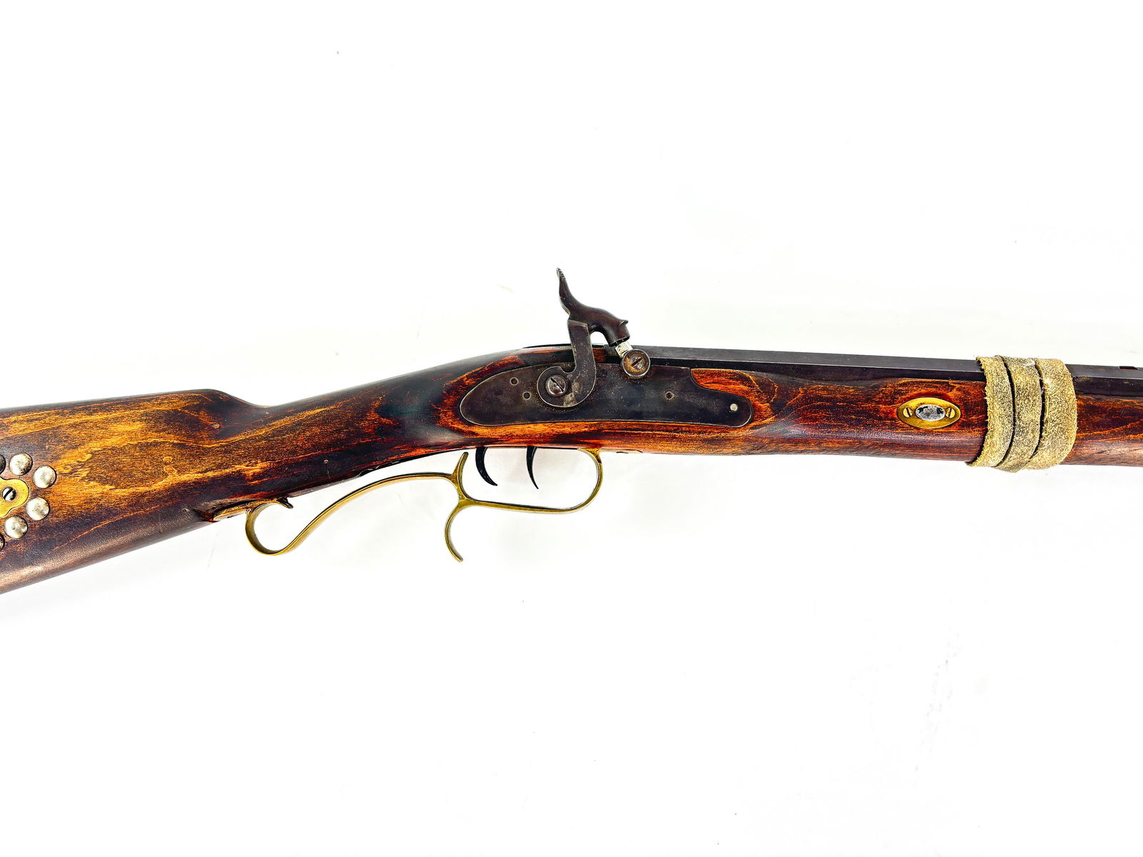 Traditions Muzzleloader Rifle: 2007 Traditions Muzzleloader percussion rifle. Made in Spain. Serial number: 19824. The ramrod is intact. The rifle has a decorative button rivet stock with a brass butt plate. Measures 55in x 1.25 in
