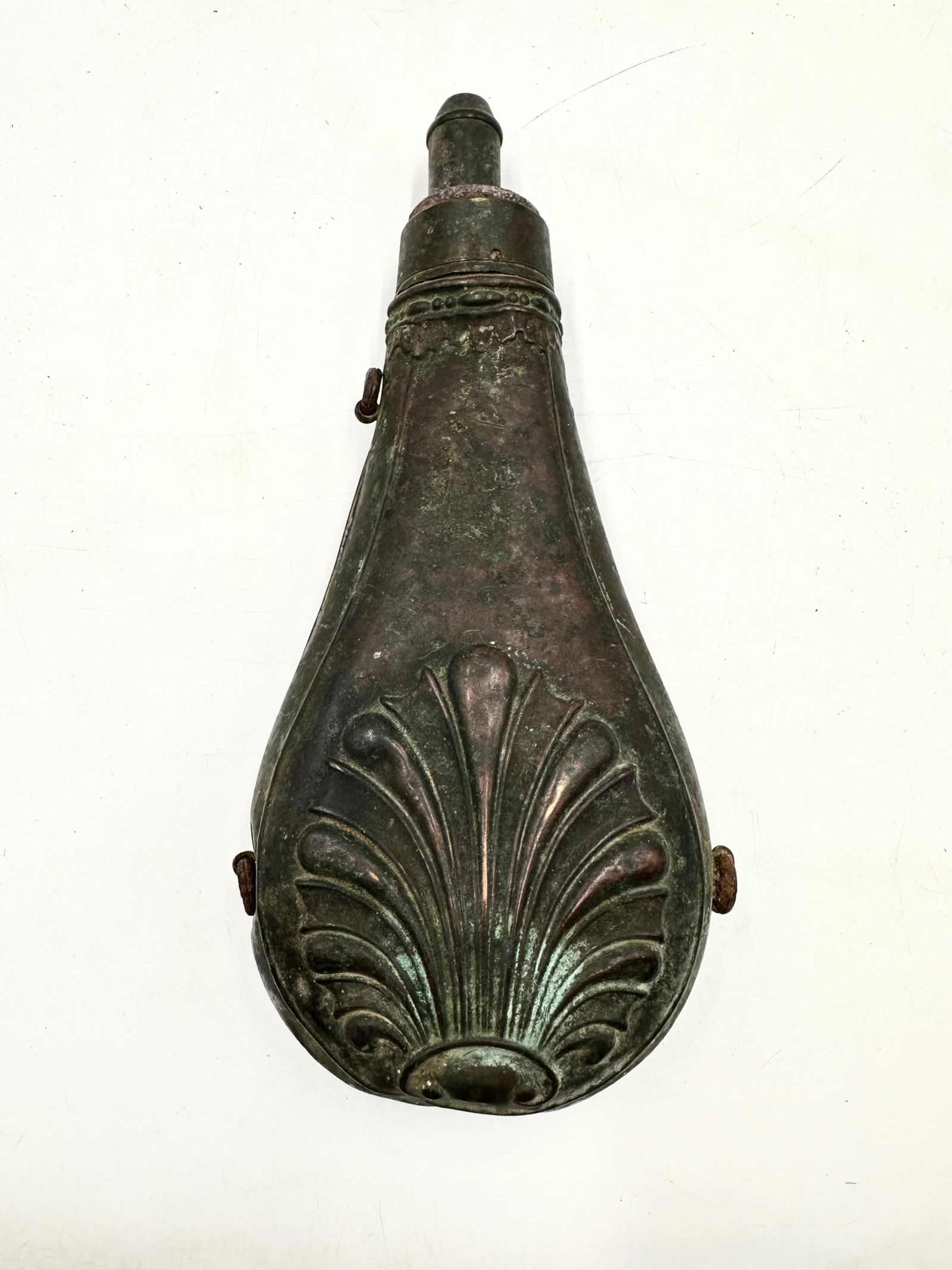 Civil War Copper Powder Flask: Copper powder flask that has major spots of patina present towards the bottom. Has a filigree design towards the base on both sides. Has a spout attachment to the top with thumb press to open and clos