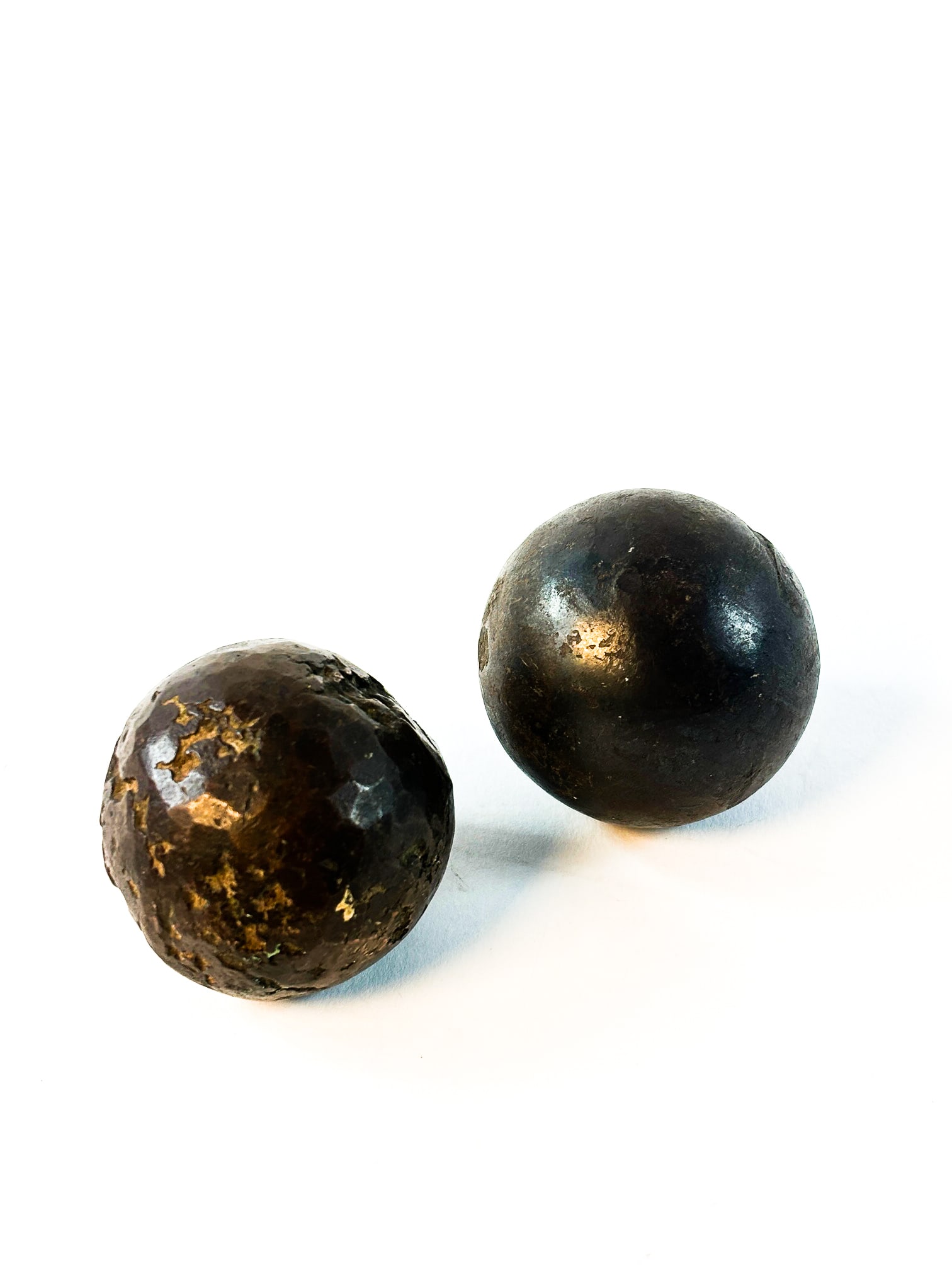 Cannon Balls: Two cannon balls. One is in rather good condition, possibly not used. The other has a few missing pieces out of the ball possibly from being fired from a cannon. Both measures roughly 7 in in diameter