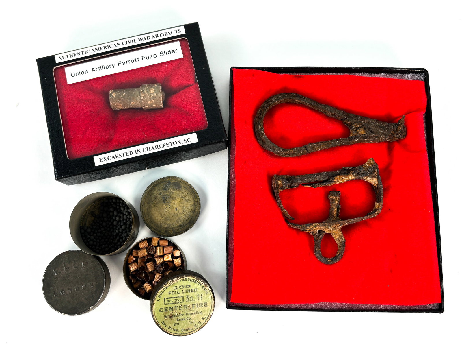 Weapon Equipment: Collection of 3 small containers made of metal to house percussion caps, one still with label included with Winchester brand on it. 1 union artillery parrott fuse slider that was excavated in Charlest