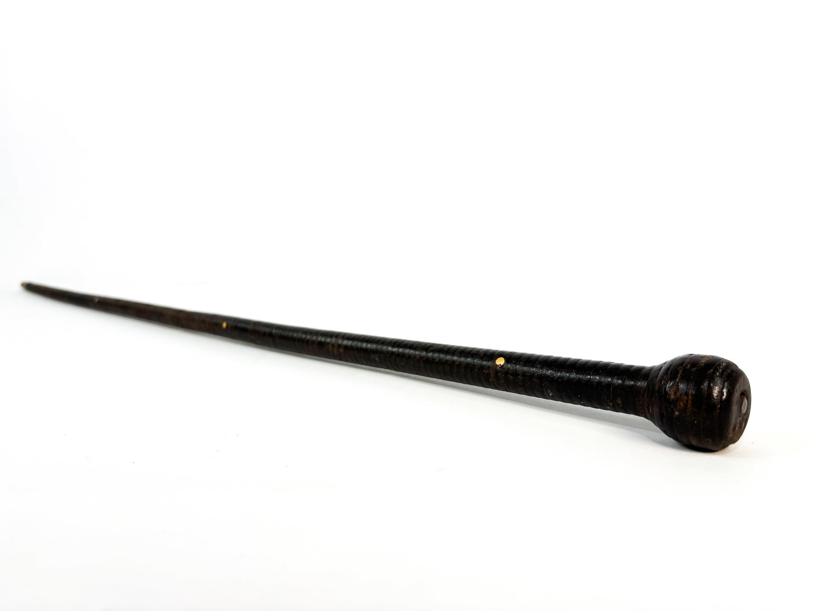 Plantation Owner Cane: Leather wrapped plantation cane and is completed with a brass tip on the bottom and top. These canes date to the Civil War era and were used by Plantation owners as a slave cane. Slight bend towards t