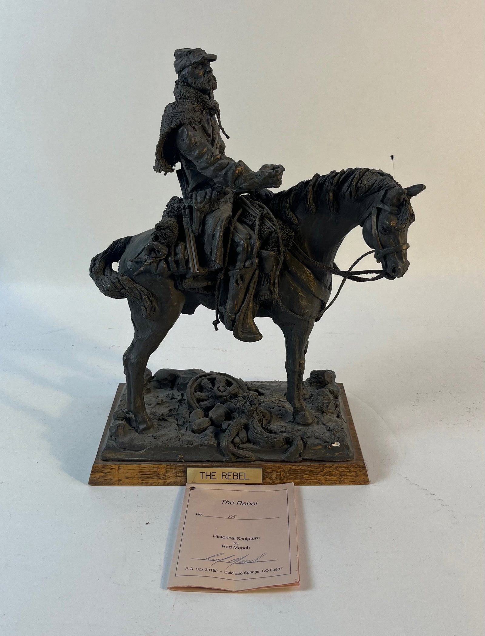 Statue Of The Rebel: Statue titled "The Rebel" by Rod Mench. This piece is a limited edition #0015 on the back of the rocks. The item is signed at the feet of the horse with detail number of where the statue falls within 