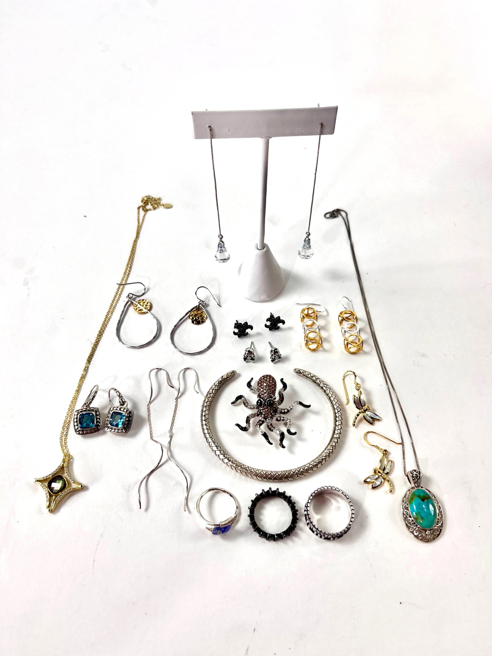 Sterling Turquoise Mystic Topaz Amethyst Jewelry: Gold tone sterling mystic topaz and glass necklace measuring 16" with a spring clasp. Sterling necklace with a turquoise pendant measuring 16" with a spring clasp. Sterling brooch with tourmaline and 