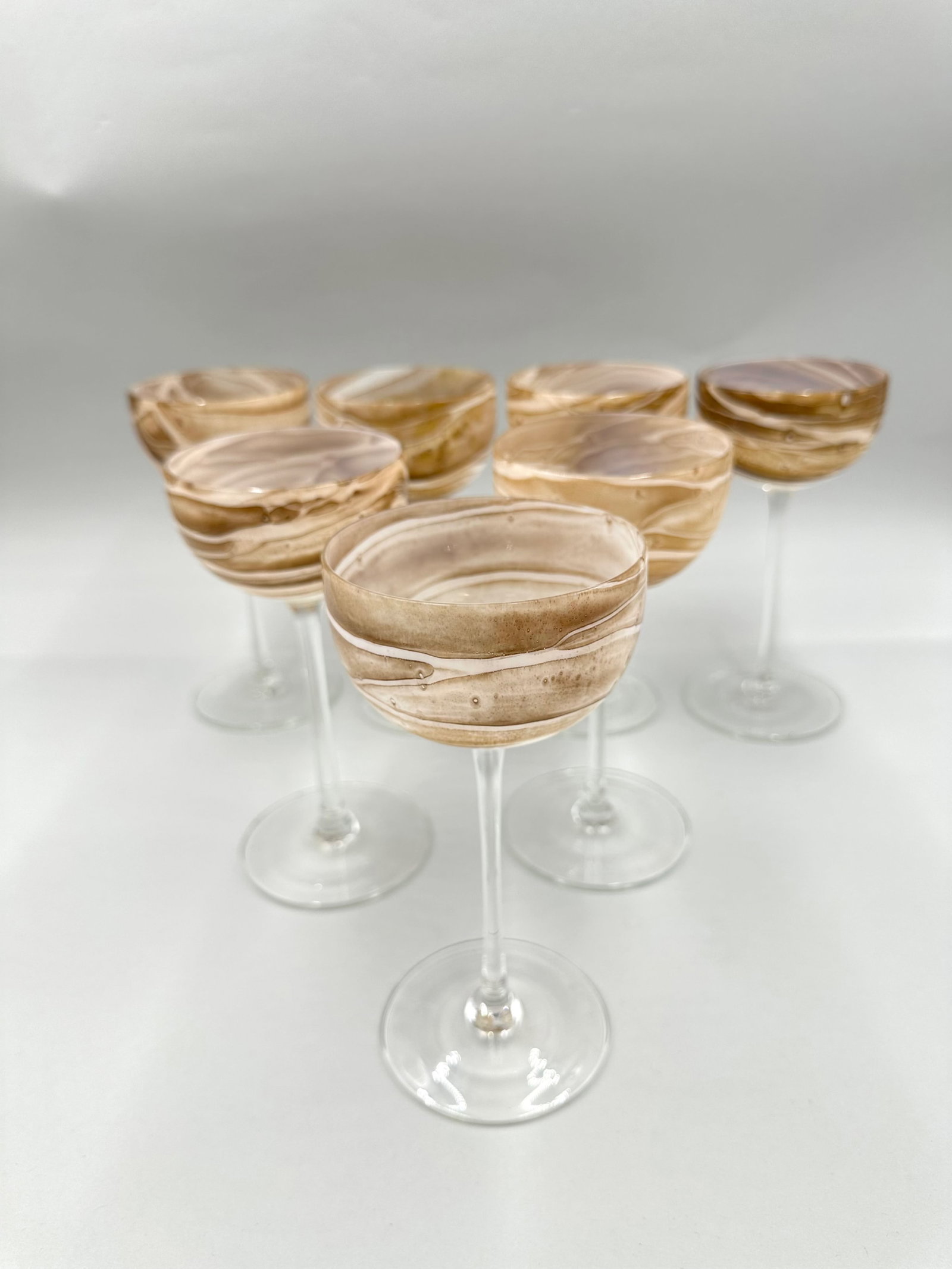 Steven Maslach Earth Art Wine Glasses: Set of seven Steven Maslach earth art wine glasses. Maslach is a glass artist from San Francisco. He has been creating and working with glass for 45 years. He has been shown in museums and galleries a