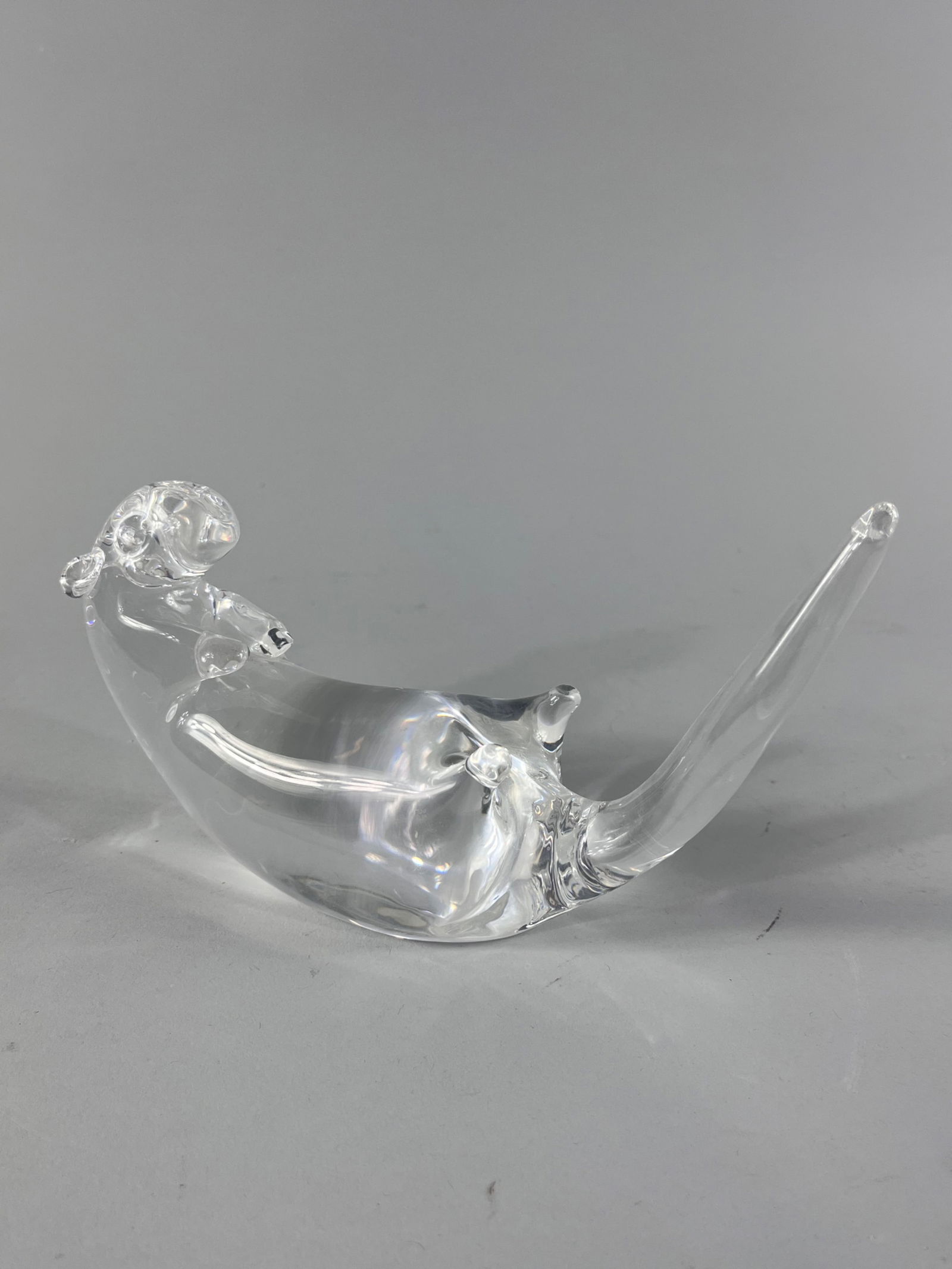 Steuben Reclining Otter Glass Figurine: This Steuben reclining otter was designed by James Houston in 1985 for the company. The piece features an engraved signature Steuben on the underside of the back of the otter. There are a few scr