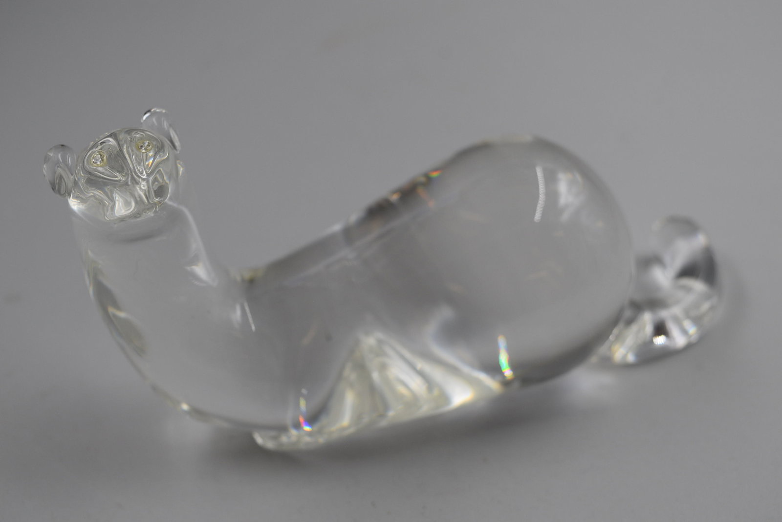 Steuben Mink Crystal with Diamond Eyes: Mink crystal sculpture with eyes of Diamond, believed to be by Lloyd Atkins in the 1970's. The Steuben mark is on the front base. There are no visible scratches or chips in the crystal. Measures 8 x 3