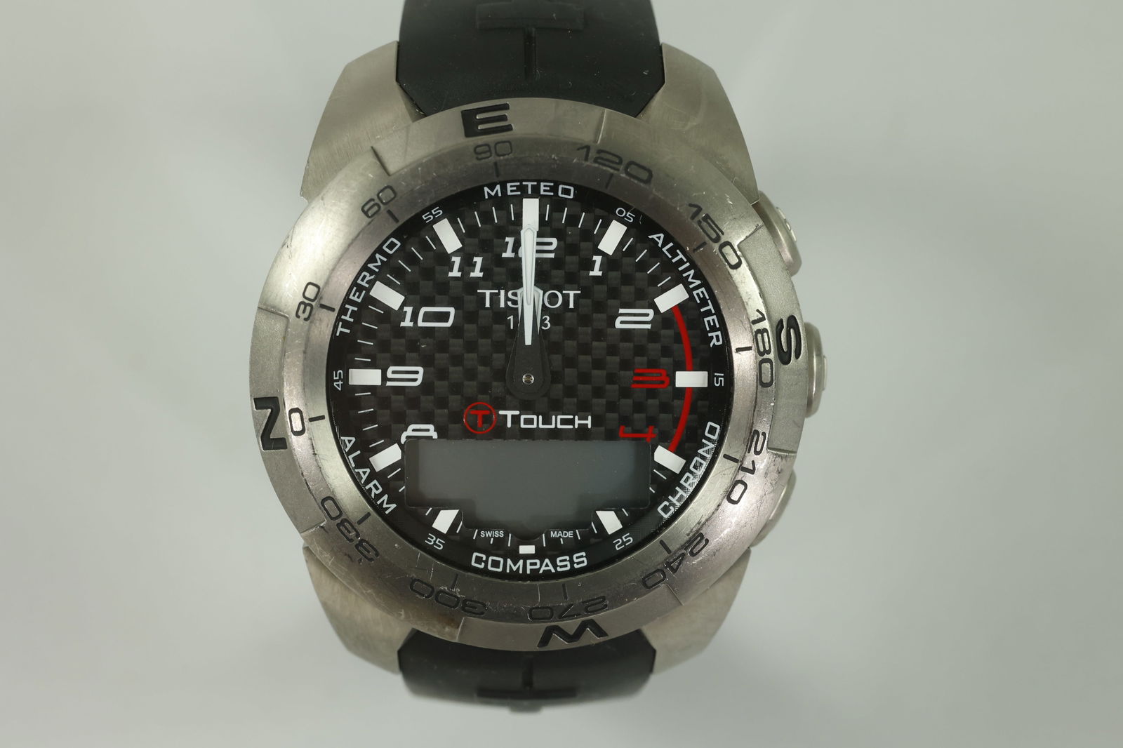 Tissot T-Touch Expert Titanium T013: Case Size: 44mm Case Material: titanium Material: titanium Bezel Color: titanium Bezel Measures: 43.35x43.35mm Crown Type: push Crystal Type: sapphire Dial Material: carbon fiber Band Material: silic