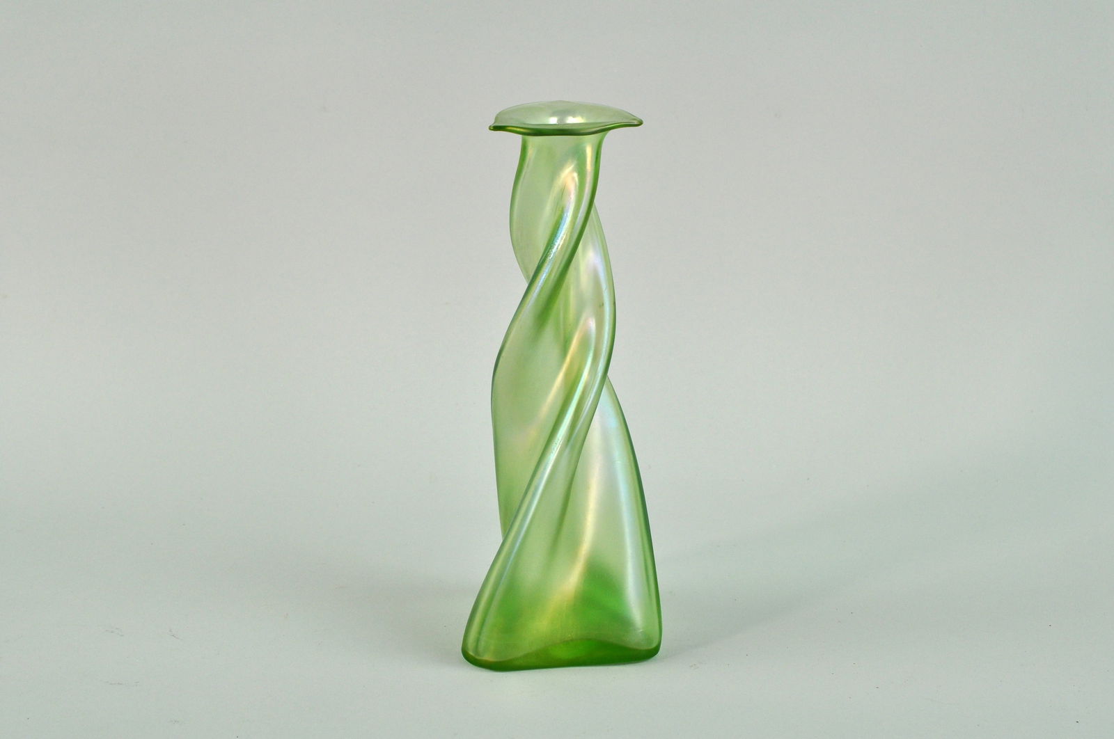 Loetz Art Nouveau Green Glass Olympia Glatt Vase: Loetz Olympia Glatt vase dates back to 1896. The light green base glass has a?light golden metallic shimmer. The rim is flared into a triangular shape and is flame-polished. The vase is in good condit