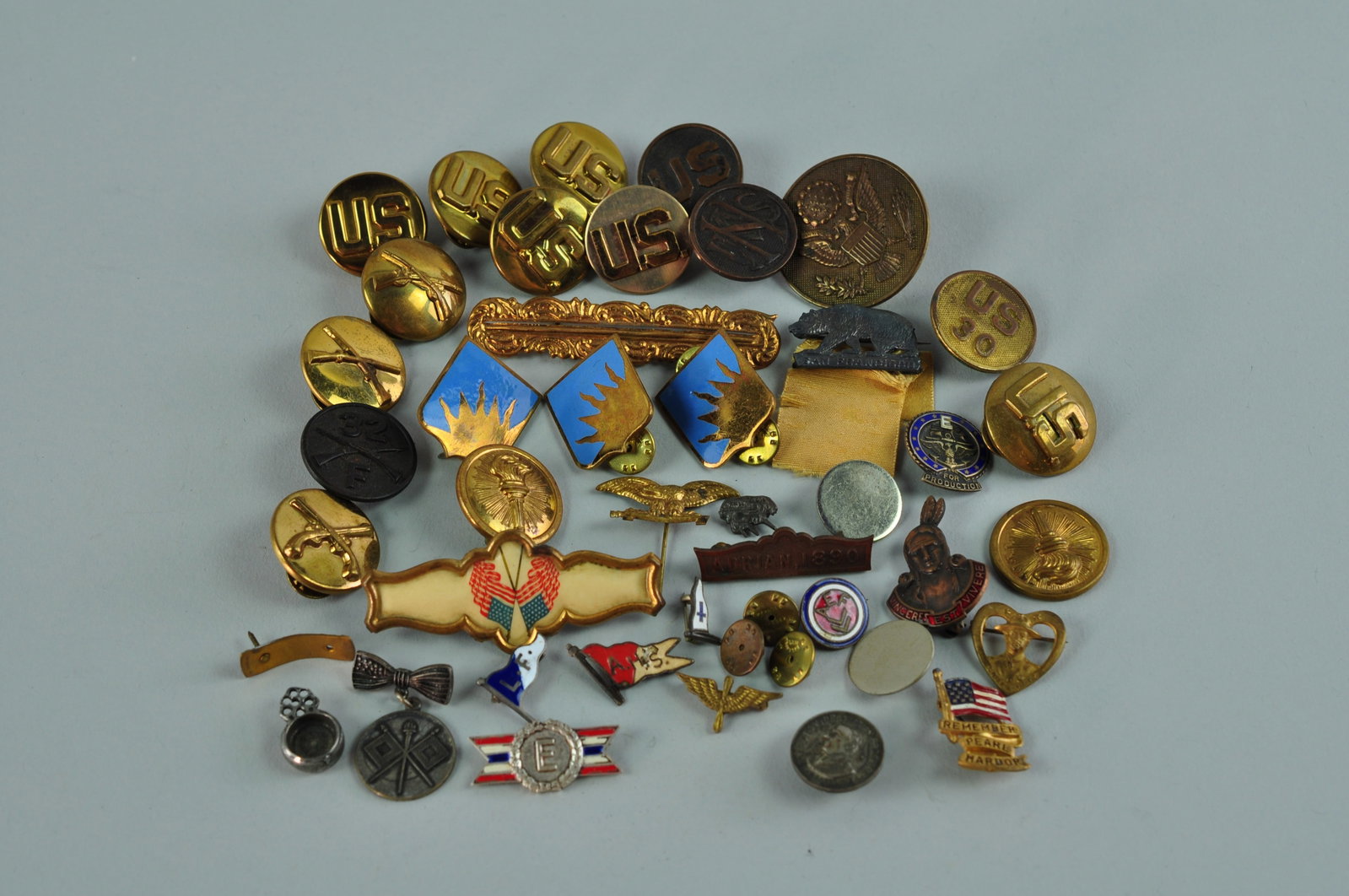 Military and an Assortment of Pins: Seven brass U.S. pins and one U.S. 30 pin. Two World War II United States Army ROTC brass pin with a torch. World War II Army enlisted infantry collar brass badge pin with t