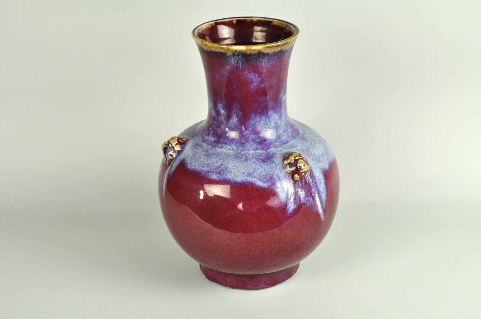 Chinese Copper Flambe Porcelain Globular Vase with Animal Masks: Chinese porcelain glazed vase decorated with with three matching animal mask around the top middle body. The vase has a long neck and bulbous body. The piece is glazed with copper flambe which is a re